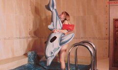 Alla quickly deflates a small inflatable dolphin in the pool!!!