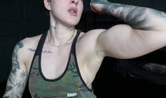A strong mistress flexing her biceps