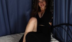 Anne: barefoot girl in black dress, cuffed on the bed with her feet in shackles and with her hands handcuffed above her head and behind the bed post, wiggles and poses to the camera (HD MOV)