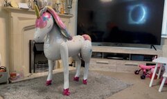 Foil unicorn balloon sit popping