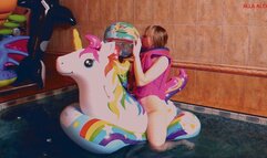 Alla naked rides an inflatable unicorn in the pool and inflates a beach ball with her mouth and plays with it!!!