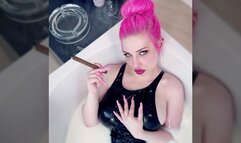 Smoking cigar in milk bath wearing PVC swimsuit