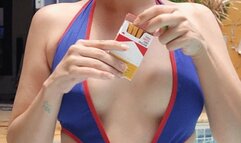 Naughty Smoking cork cigarette in a swimsuit by the pool