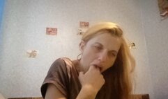 Old shabby woman induces vomiting