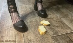 Crushing stale bread with My heeled sandals, spitting on it and making My slave eat it from the floor