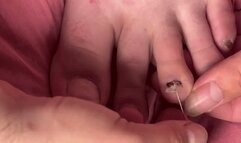 poking a fake fingernail with pins