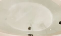 Carissa in the bathtub in the neon green half shirt and goggles-a sensual exploration