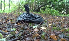 Litter, crushed plastic model train houses in forest wearing Timberland Boots