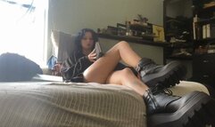 Maeve ignores you with her boots and a book