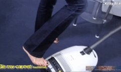 Kitty Blair barefoot vacuuming in blue jeans