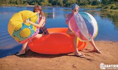 Q886 Cosette and Stashia blow two big beach balls on a lake - 1080p