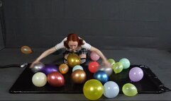 Sonya balloons in a black latex bed