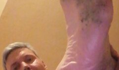 Dirty feet of mine, kneel down on the floor while looking at my dirty foot