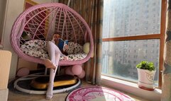 girl in white tights and expensive high-heeled sandals enthusiastically reads a book and plays with shoes