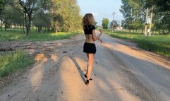 a girl in high heels wades through the mud, her shoes get stuck and she falls straight into the mud