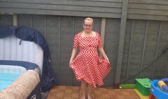 striptease in 50s red dress with stockings and suspenders