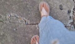 Flipflops walking stepping on plastic bottle