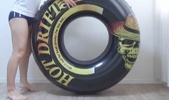 Wearing gym clothes and bloomers, ride vertically on the float