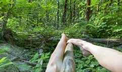 Footjob on wood in nature