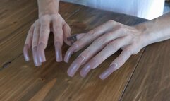 Long claws tapping wooden table