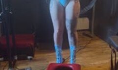 Latex clad mistress covers female slave in her champagne