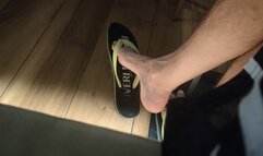 Male feet dangling my flip flops at the restaurant (avi)