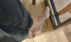 Long and skinny feet dipping wrecked shoes at the mall