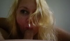 Blonde blows a cock, close-up.