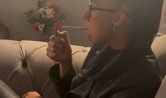 Smoking in full leather outfit on sofa