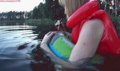 Alla swims on an inflatable ring in the lake and POPs it with a stick and wears a red inflatable vest on her naked body!!!