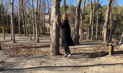 girl in mules walks in the park through the mountains and constantly loses her shoes, staining her white tights with dirt