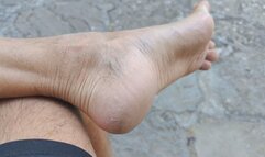 On a public bench, my feet and heels need to be scratched