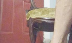 Tempest sitting in gold chair with witchy heels