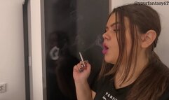 Smoking with purple lipstick close-up side view