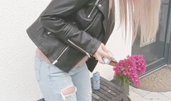 Casual smoking in leather jacket and tight ripped jeans