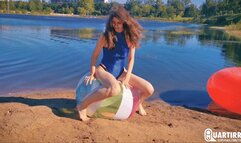 Q906 Cosette rides and deflates big beachball on a lake - 480p