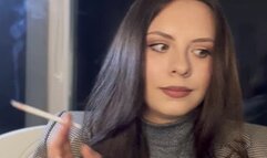 Smoking long white cigarette on classic stylish look