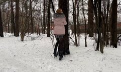 a girl walks through the winter forest in extremely high heels ballet boots