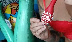 blowing red balloon on infatable and nailpop