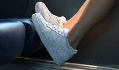 Rude girl places her dirty sneakers shoes on the train seat