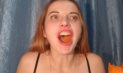 The mouth engulfs the fruit, tearing and pulverizing it