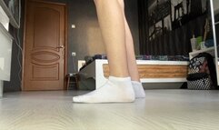 girl in a school uniform teases the viewer with her feet in socks, shows them close to the camera and plays with them, and then jerks off a toy