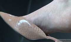 Beauty sexy feet in a candid dangling with elegant slipper sandals, perfect arched and heels