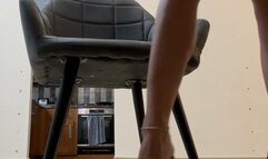 Short blue jeans and blue perspex heels under the table