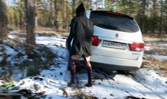 Hot chick in high heel boots gets stuck in the woods with a car and tries to get it out falls down and rolls around in the mud