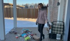 girl in high-heeled boots crushes cardboard and boxes and enjoys it