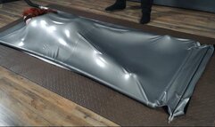 Flogging in a gray latex bed upside down with vibro and eyes closed