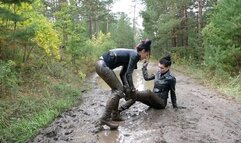 Two leather-clad hotties wrestling in the mud