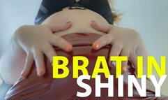 Brat in shiny red pants