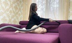 The cleaning lady was playing with the vacuum cleaner